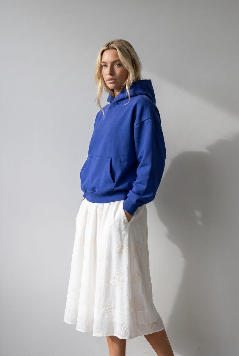 Generated photo of the model wearing the cobalt hoodie with the midi skirt