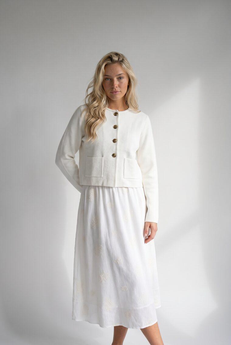 Generated photo of the model wearing the cropped jacket with the midi skirt