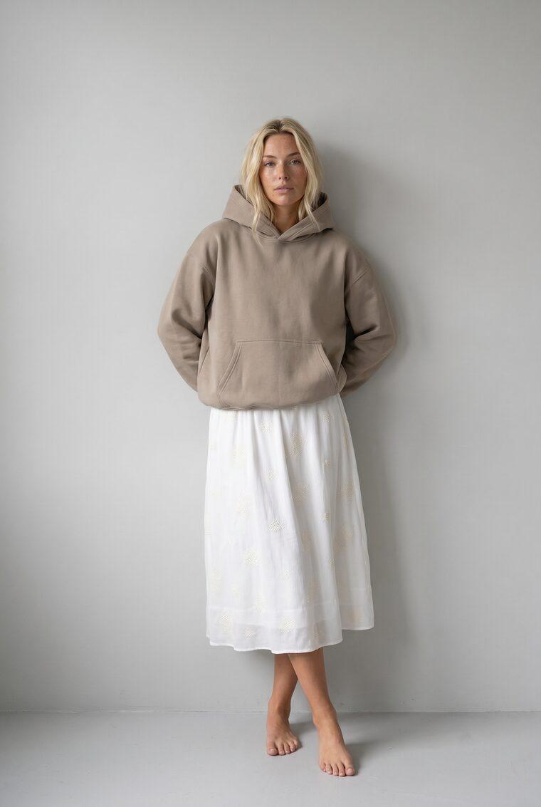 Generated photo of the model wearing the taupe hoodie with the midi skirt