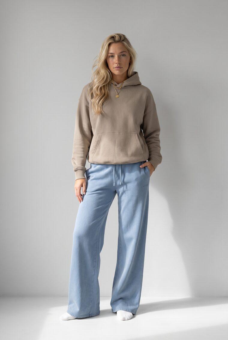 Generated photo of the model wearing the taupe hoodie with the wide-leg pants